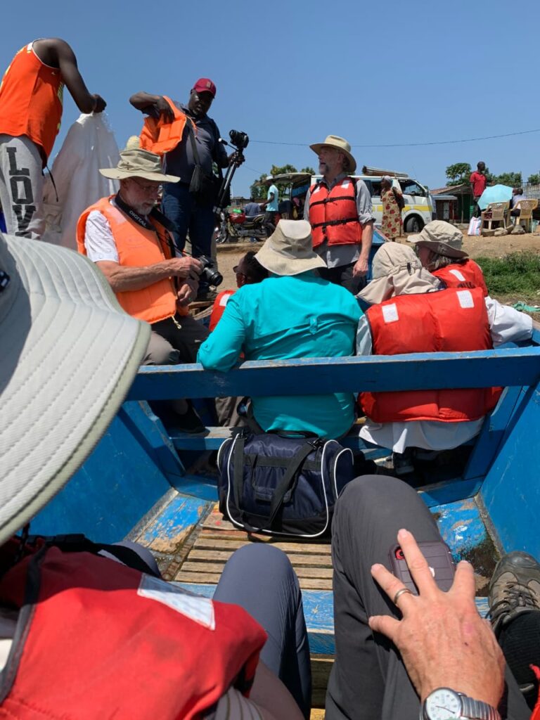 Group of tourists in life vests on a Lake Victoria boat tour