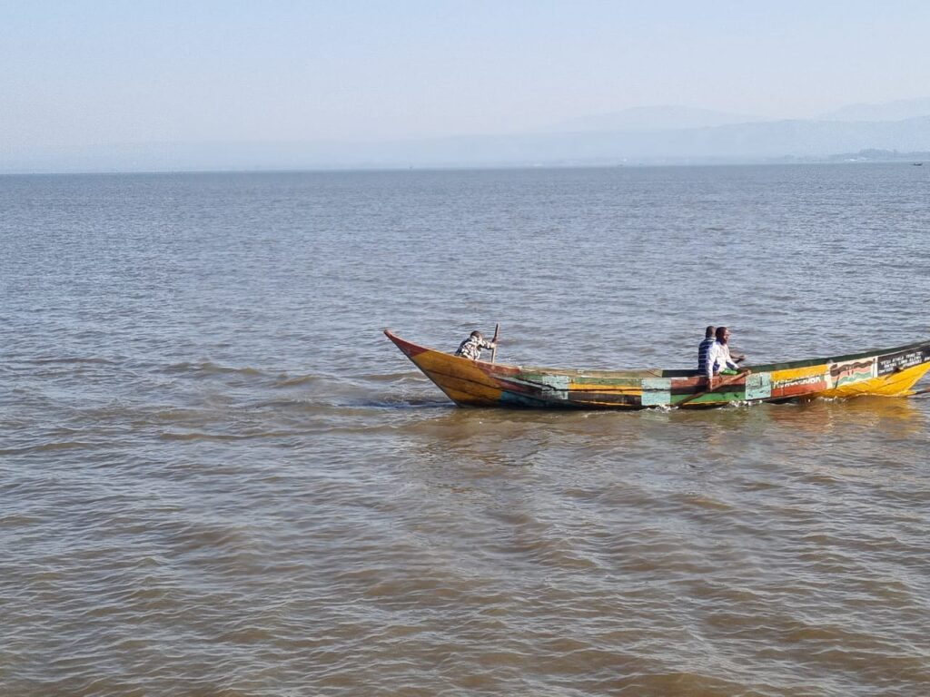 Small boat floating on Lake Victoria